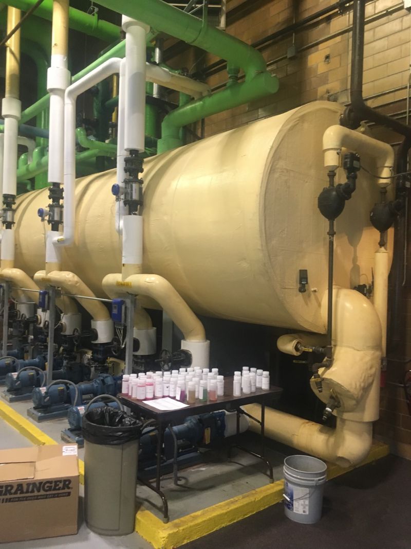 Insulated commercial hydronic storage tank with circulating pumps and water treatment test samples